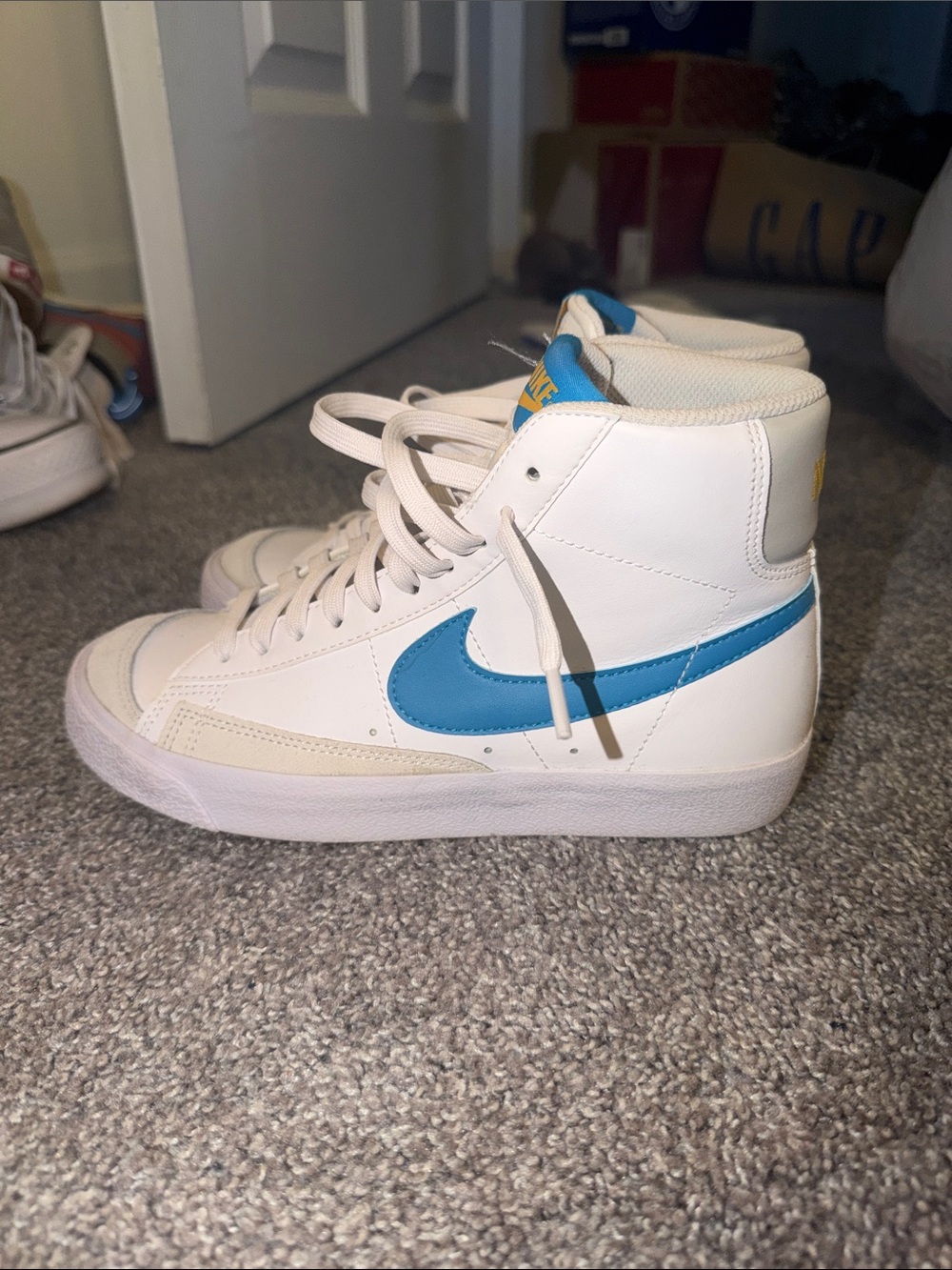 Nike White High-Top Sneakers with Blue Swoosh